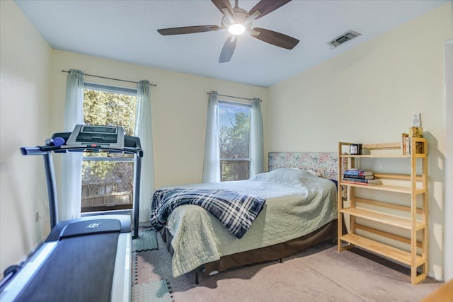 bedroom featuring ceiling fan, multiple windows, carpet, and visible vents