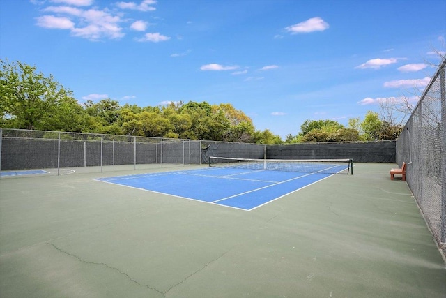 view of sport court featuring fence