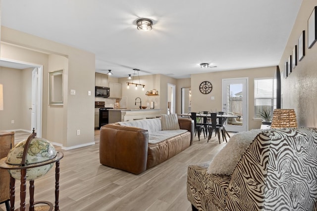 living room featuring baseboards and light wood-style floors