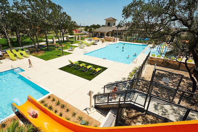 community pool featuring a patio and fence