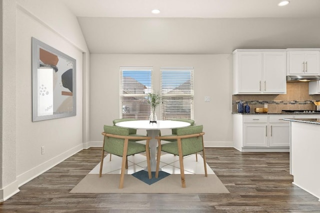 dining room featuring baseboards, vaulted ceiling, dark wood-type flooring, and recessed lighting