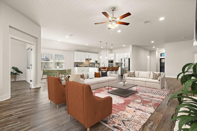 living area with baseboards, visible vents, ceiling fan, wood finished floors, and recessed lighting