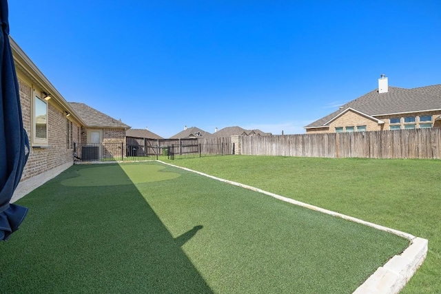 view of yard featuring a fenced backyard and central AC unit