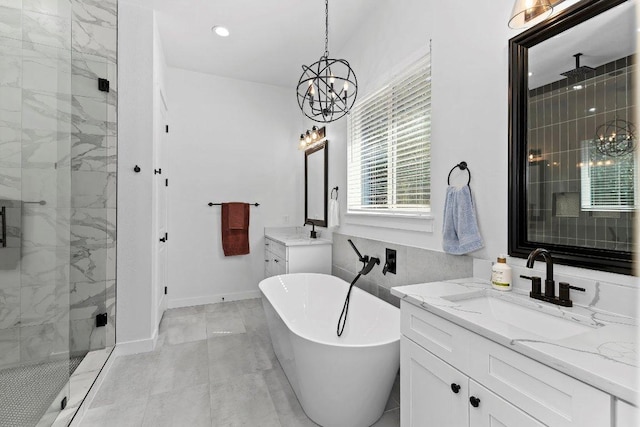 101 Saddle Mtn, Boerne, TX 78006 - bathroom featuring a chandelier, a stall shower, a freestanding bath, two vanities, and baseboards