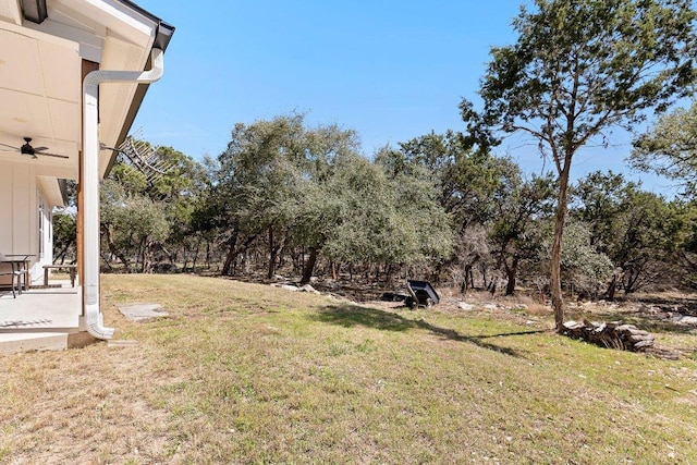 101 Saddle Mtn, Boerne, TX 78006 - view of grassy yard featuring a ceiling fan and view of wooded area