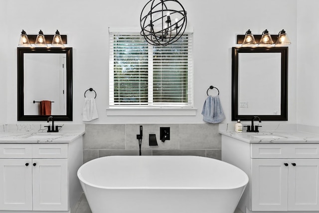 101 Saddle Mtn, Boerne, TX 78006 - bathroom with two vanities, a freestanding bath, and a chandelier