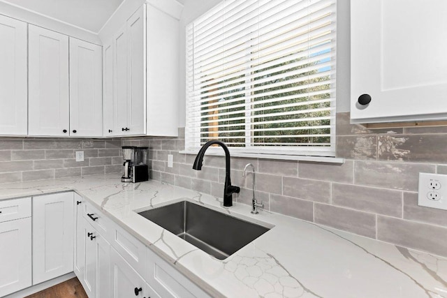 101 Saddle Mtn, Boerne, TX 78006 - kitchen with a sink, white cabinetry, tasteful backsplash, and light stone countertops