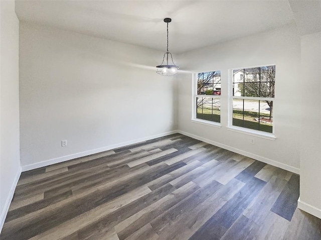 127 Campos Dr, Hutto, TX 78634 - unfurnished dining area featuring baseboards and dark wood-style floors