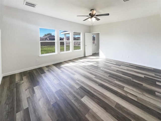 empty room featuring baseboards, visible vents, ceiling fan, and wood finished floors