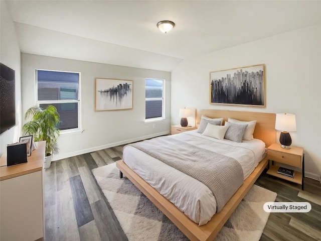 bedroom featuring wood finished floors and baseboards