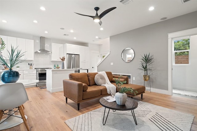 living room featuring recessed lighting, visible vents, ceiling fan, light wood-type flooring, and baseboards