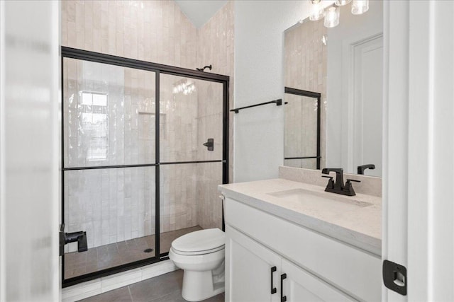 bathroom with toilet, a shower stall, tile patterned flooring, and vanity