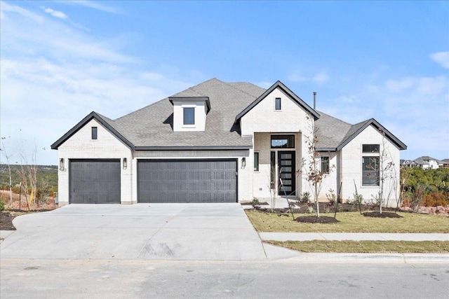 view of front of property featuring a garage, concrete driveway, brick siding, and a shingled roof