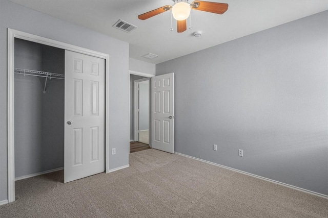 unfurnished bedroom with baseboards, visible vents, ceiling fan, carpet, and a closet