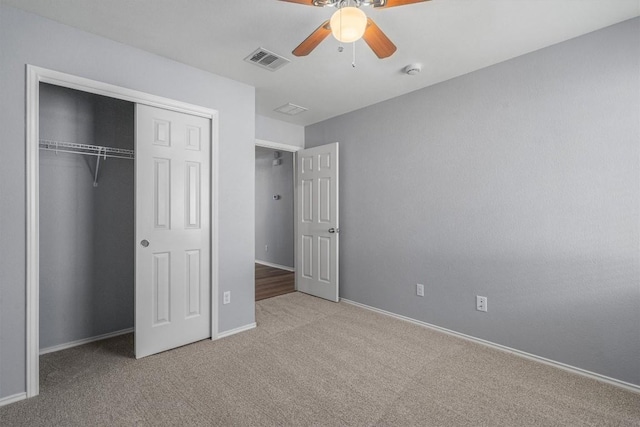 unfurnished bedroom featuring baseboards, visible vents, ceiling fan, carpet floors, and a closet