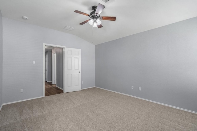 spare room with visible vents, baseboards, ceiling fan, carpet, and vaulted ceiling