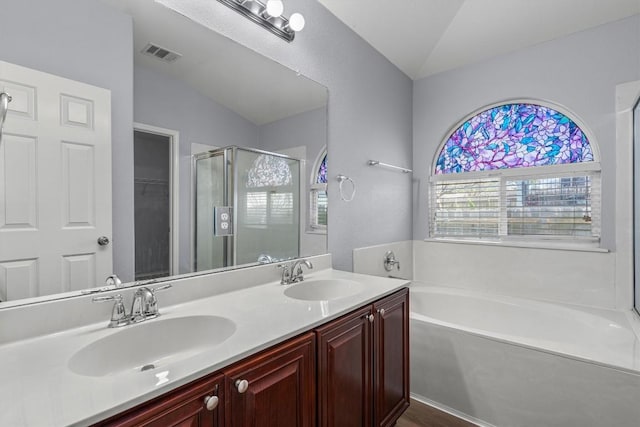 bathroom with lofted ceiling, a sink, visible vents, and a shower stall