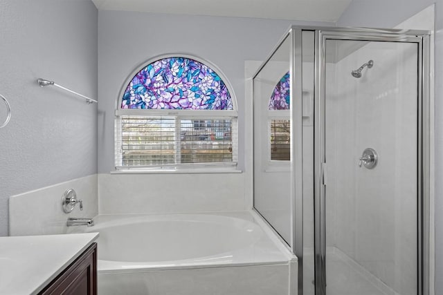 full bath with a stall shower, a garden tub, and vanity