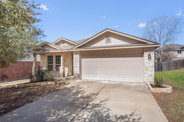 ranch-style home featuring a garage, stone siding, fence, and driveway