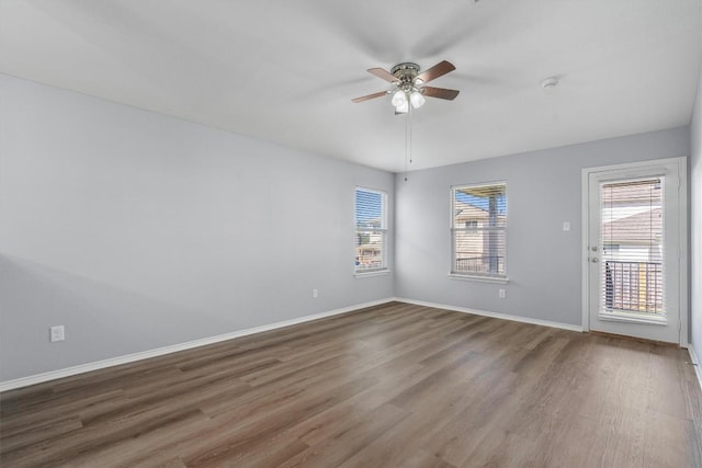 unfurnished room with ceiling fan, baseboards, and wood finished floors