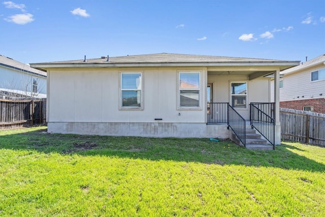 exterior space with a lawn and fence