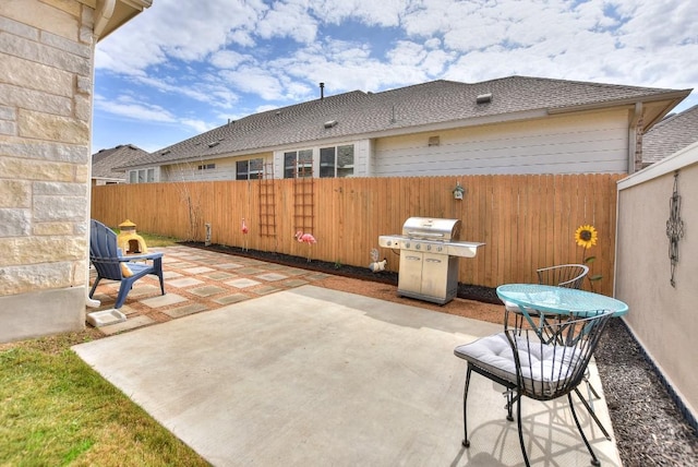 view of patio featuring fence and grilling area