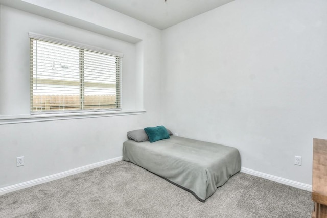 carpeted bedroom featuring baseboards