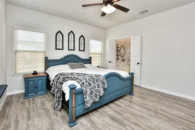 bedroom with visible vents, a ceiling fan, wood tiled floor, connected bathroom, and baseboards