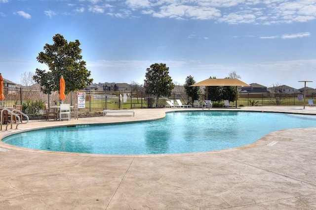 pool featuring fence and a patio