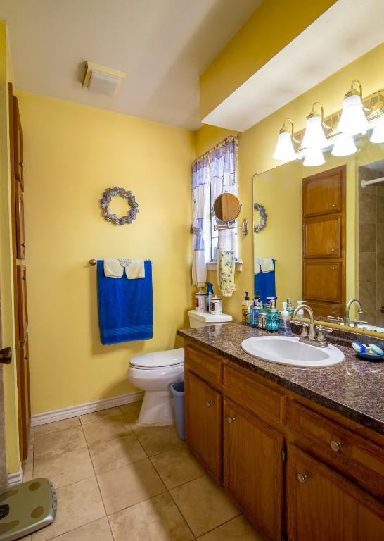 full bathroom featuring baseboards, a shower, toilet, tile patterned floors, and vanity