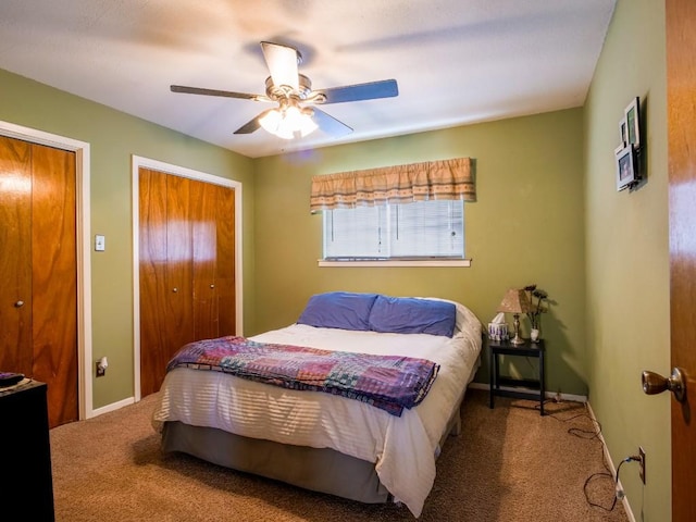 bedroom featuring carpet, baseboards, ceiling fan, and multiple closets