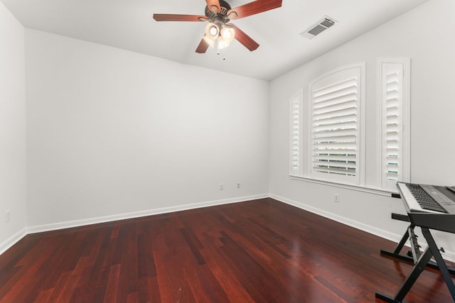 unfurnished office featuring baseboards, visible vents, ceiling fan, and wood finished floors