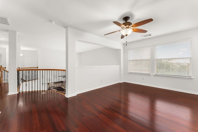 unfurnished room featuring a ceiling fan, baseboards, visible vents, and hardwood / wood-style floors