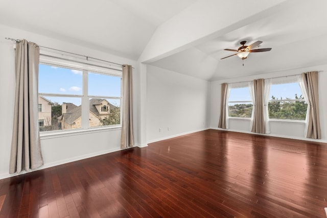 empty room featuring lofted ceiling, ceiling fan, hardwood / wood-style flooring, and baseboards