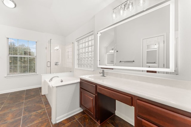 bathroom featuring baseboards, a shower stall, vanity, and a bath