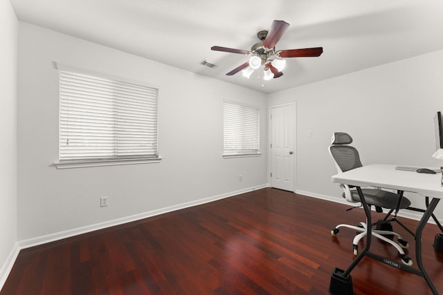 home office with baseboards, visible vents, ceiling fan, and wood finished floors