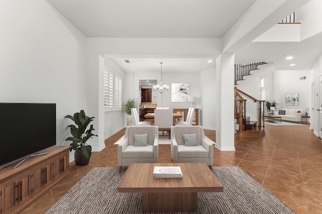 living room with visible vents, stairway, an inviting chandelier, tile patterned flooring, and baseboards