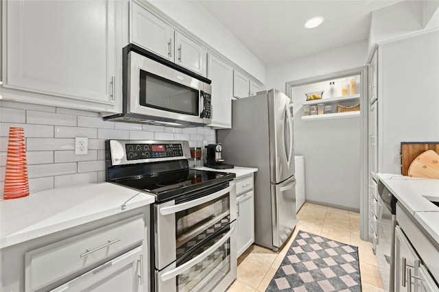 kitchen with light stone counters, light tile patterned floors, stainless steel appliances, recessed lighting, and backsplash