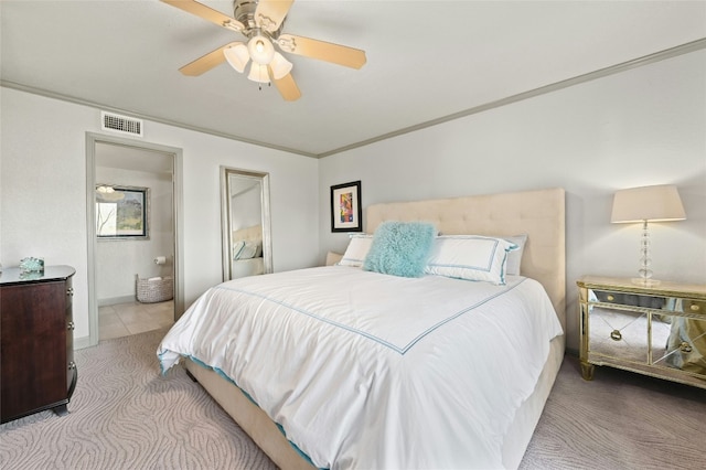 carpeted bedroom with connected bathroom, visible vents, crown molding, and ceiling fan