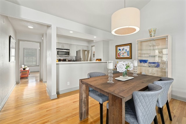 dining space with light wood-style floors, recessed lighting, and baseboards