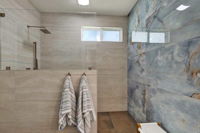 full bath featuring walk in shower and wood finished floors