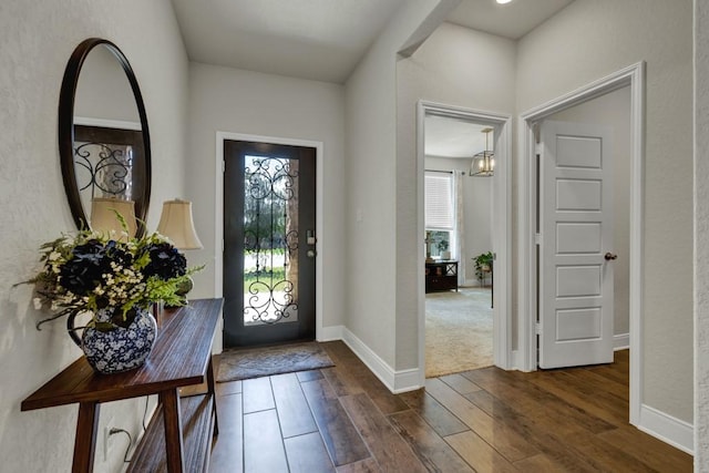 entrance foyer featuring dark wood-style floors and baseboards