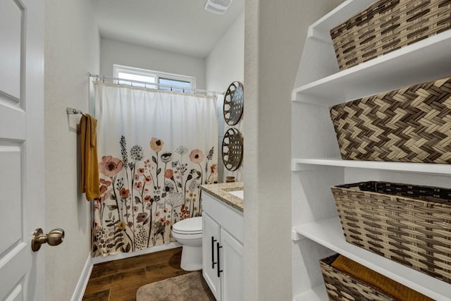 bathroom featuring visible vents, toilet, wood finished floors, curtained shower, and vanity