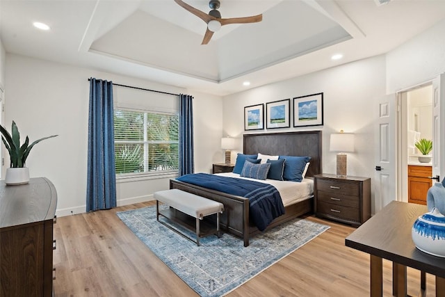 bedroom with light wood finished floors, recessed lighting, a raised ceiling, a ceiling fan, and baseboards