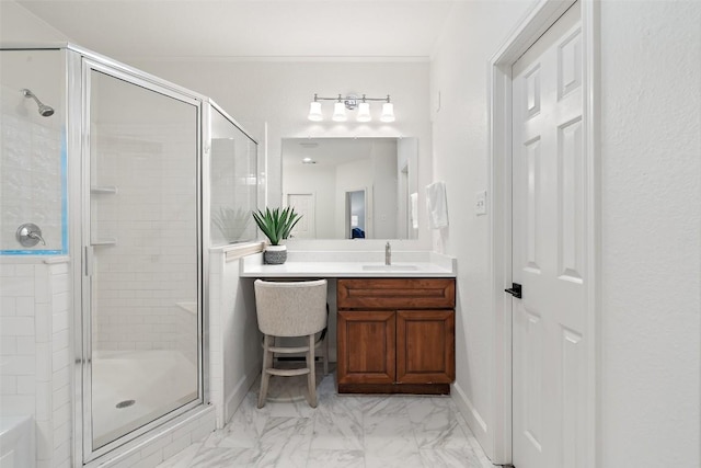 bathroom featuring vanity, baseboards, marble finish floor, ornamental molding, and a shower stall