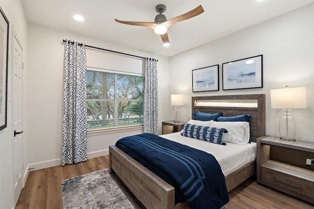 bedroom featuring ceiling fan, baseboards, wood finished floors, and recessed lighting