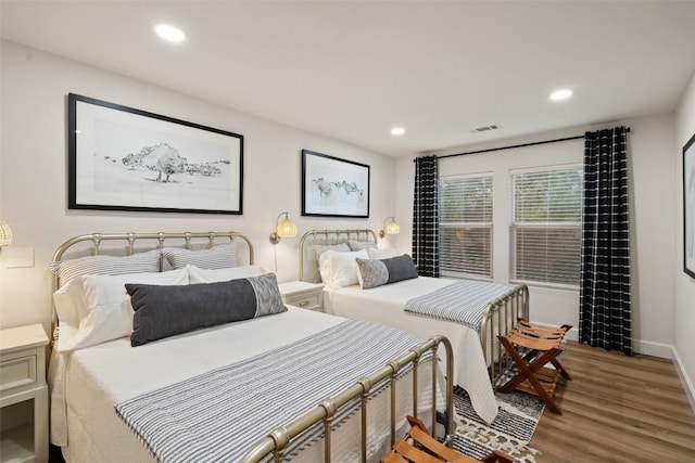 bedroom featuring wood finished floors, visible vents, and recessed lighting