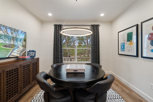 dining room featuring light wood-type flooring, baseboards, and recessed lighting