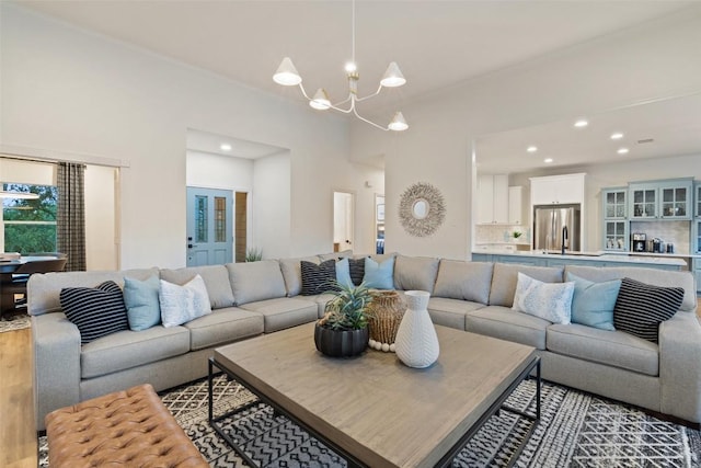 living room with an inviting chandelier, wood finished floors, and recessed lighting