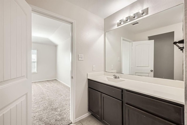 bathroom with vanity, visible vents, and baseboards